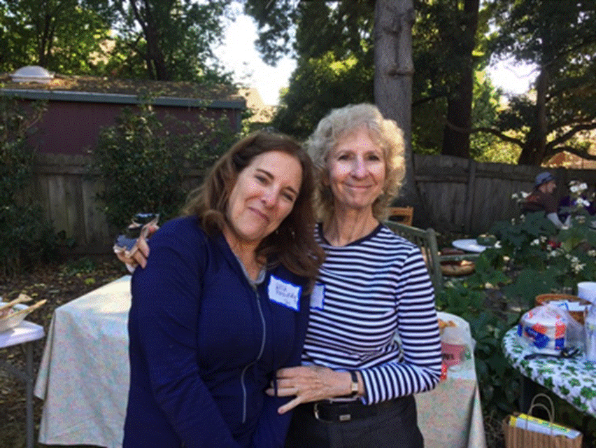 Two people posing for a picture Description automatically generated