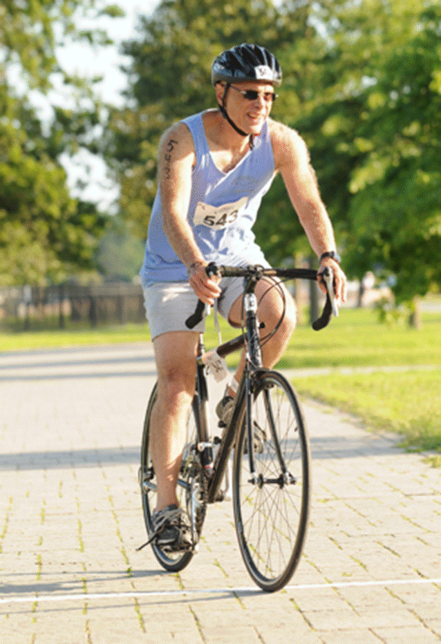 A person riding on the back of a bicycle Description automatically generated