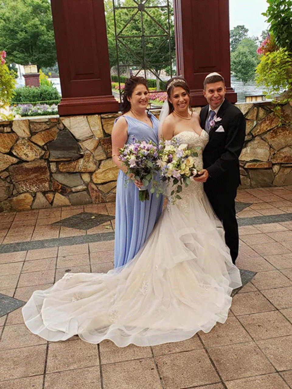 A person standing in front of a statue Description automatically generated