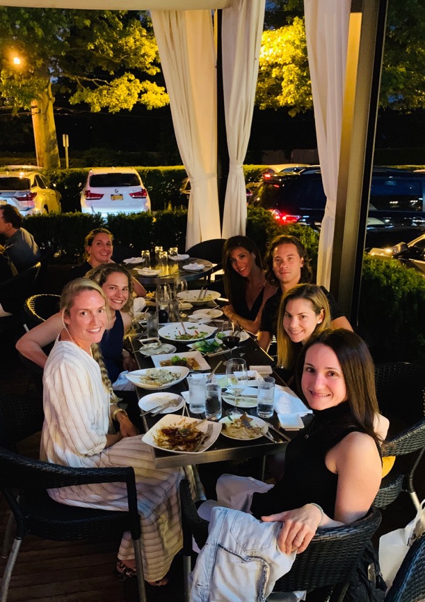 A group of people sitting at a table Description automatically generated