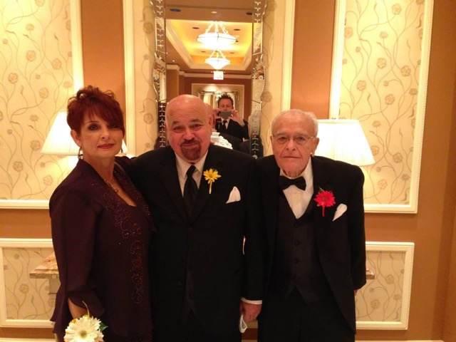 A group of people standing in front of a mirror posing for the camera
Description automatically generated