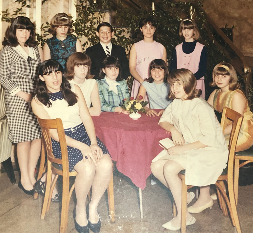 A group of people sitting posing for the camera
Description automatically generated