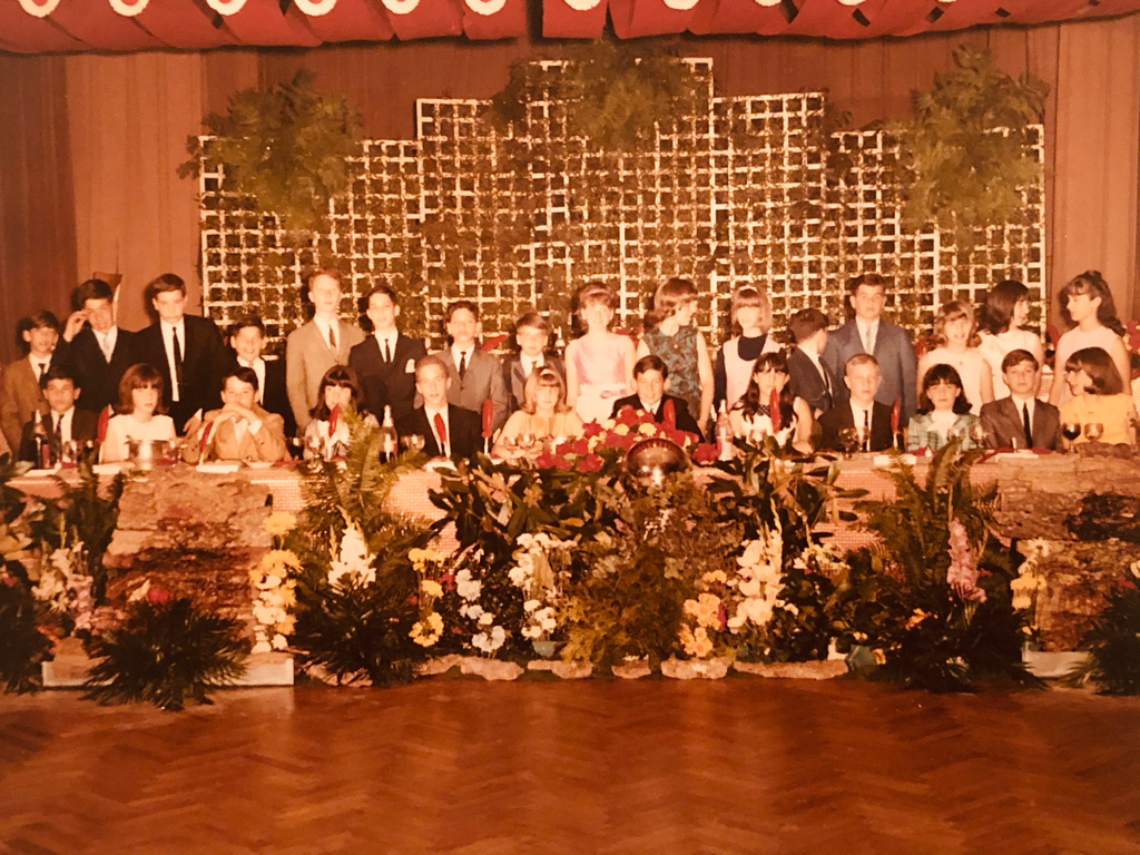 A group of people standing in front of a crowd
Description automatically generated