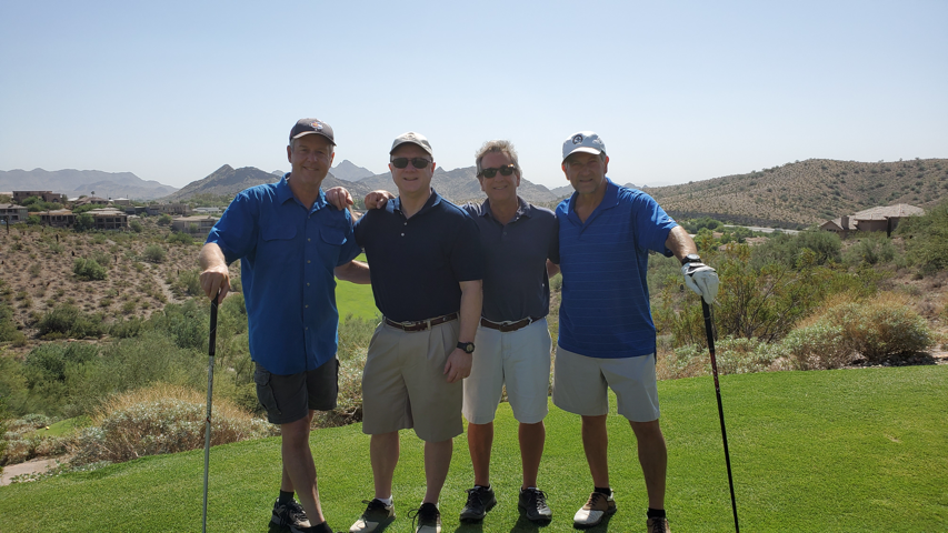 A group of people standing on top of a grass covered field
Description automatically generated