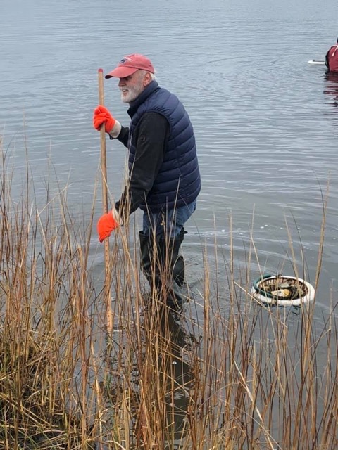 A person standing next to a body of water

Description automatically generated
