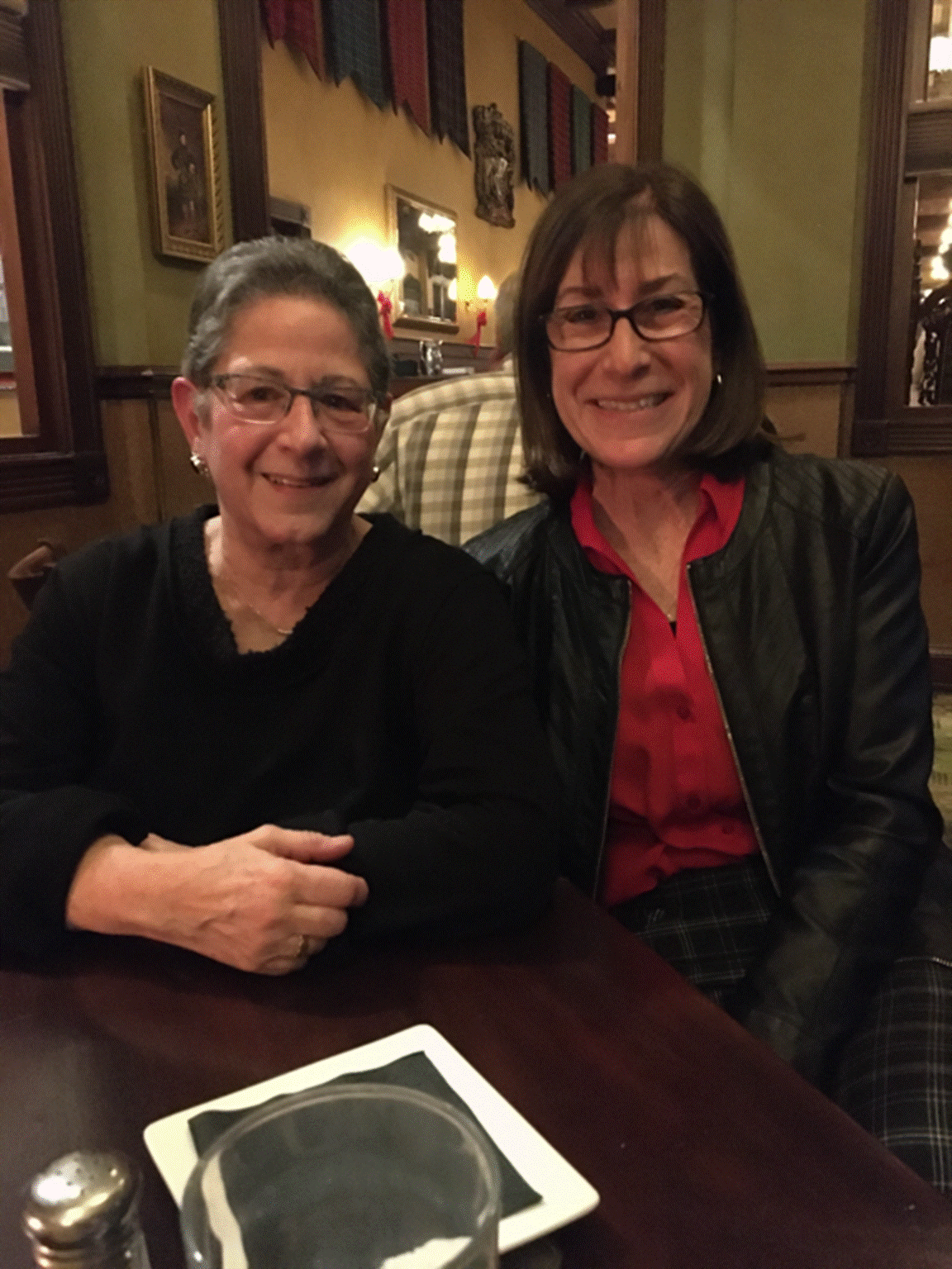 A group of people sitting at a table posing for the camera

Description automatically generated