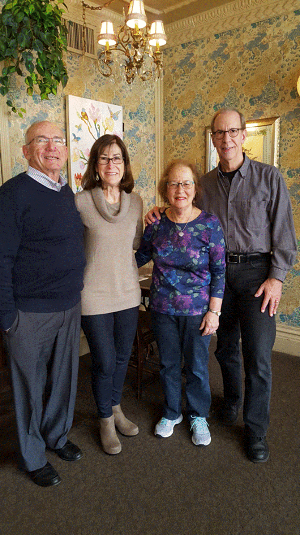 A group of people standing in a room

Description automatically generated