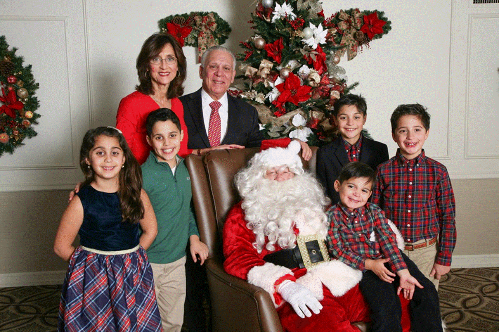 A group of people standing in a room

Description automatically generated