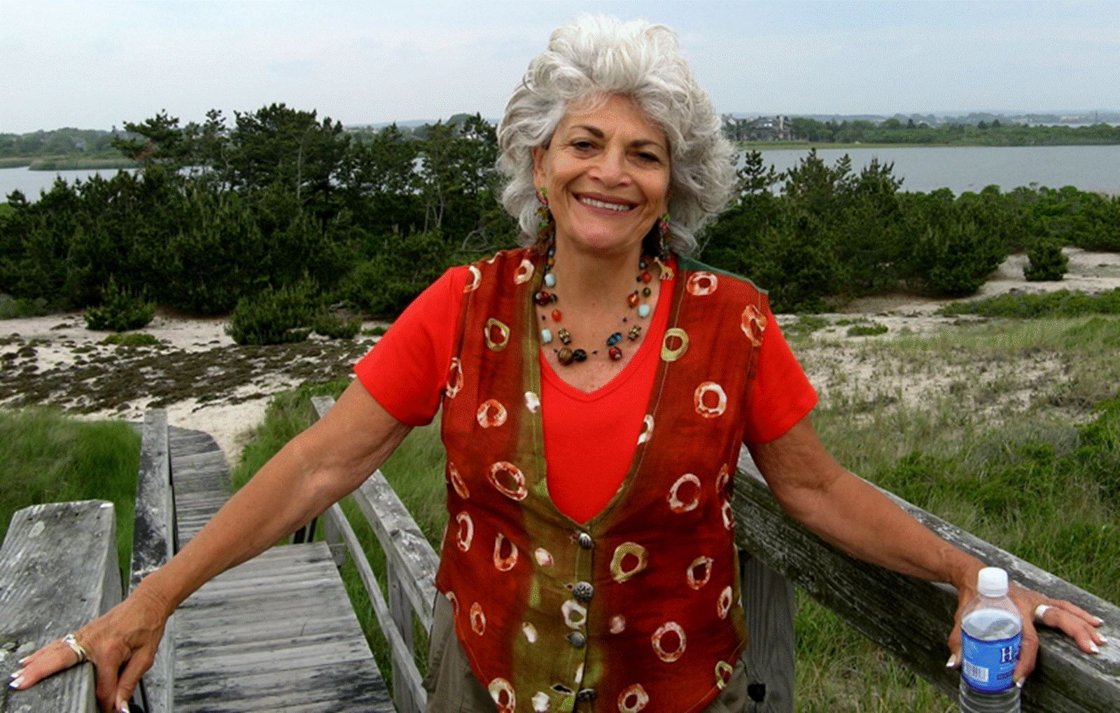 A person standing next to a body of water
Description automatically generated