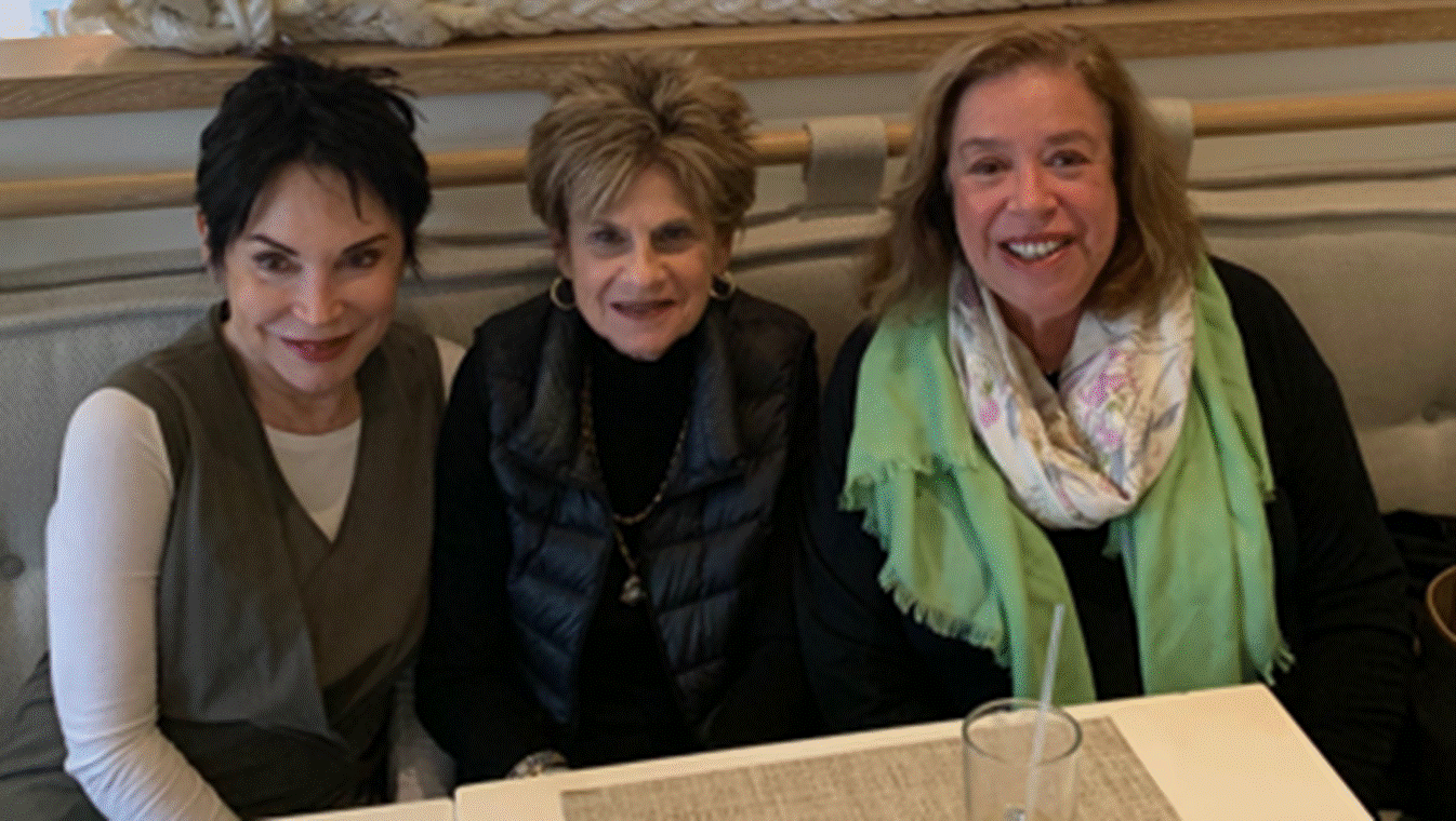 A group of people sitting at a table
Description automatically generated