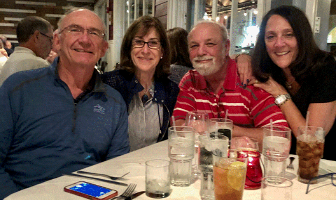 A group of people sitting at a table with wine glasses
Description automatically generated