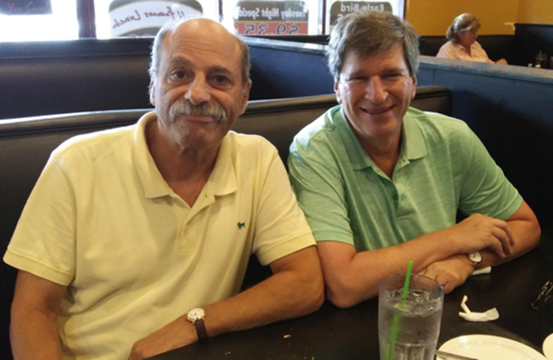 A person sitting at a table in a restaurant
Description automatically generated