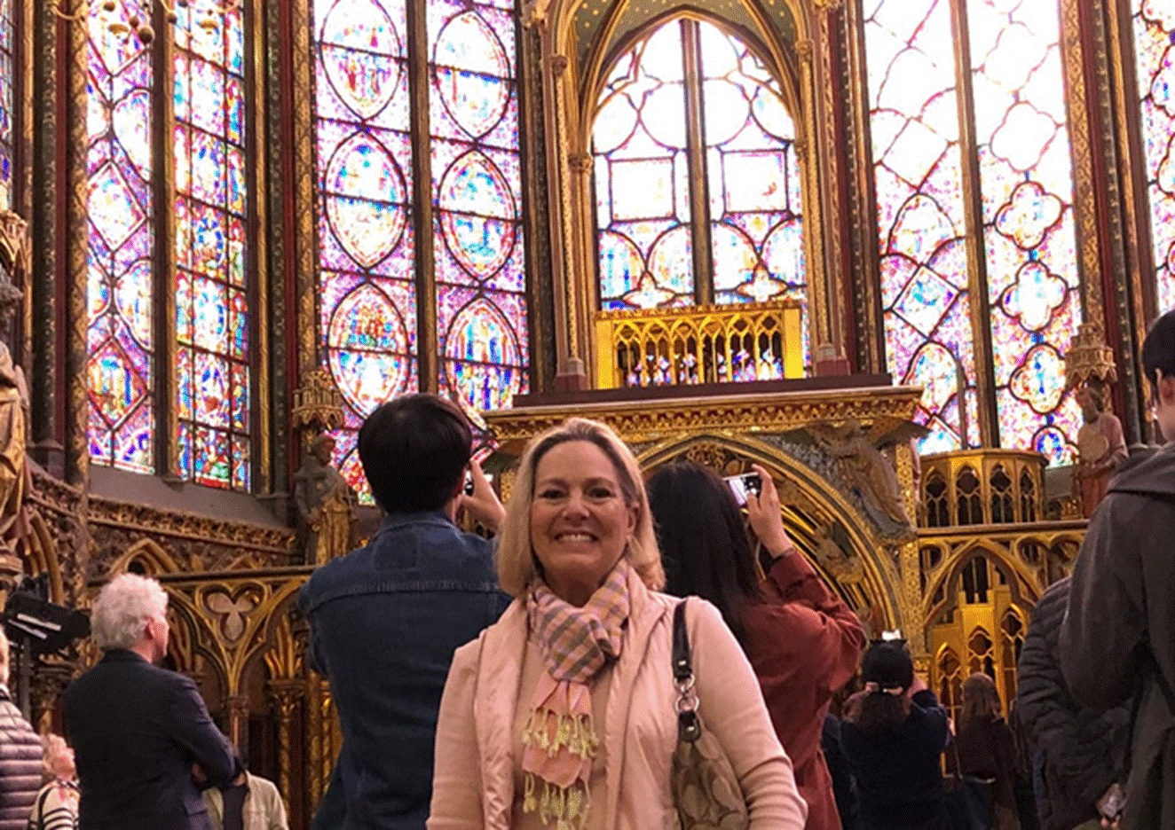 A group of people standing next to a window
Description automatically generated