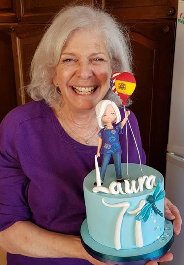 A person holding a birthday cakeDescription automatically generated