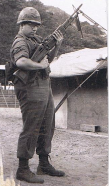 A person standing in front of a buildingDescription automatically generated