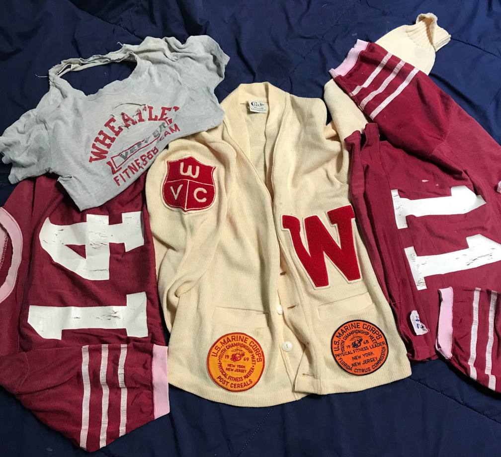 A group of clothes on a bedDescription automatically generated